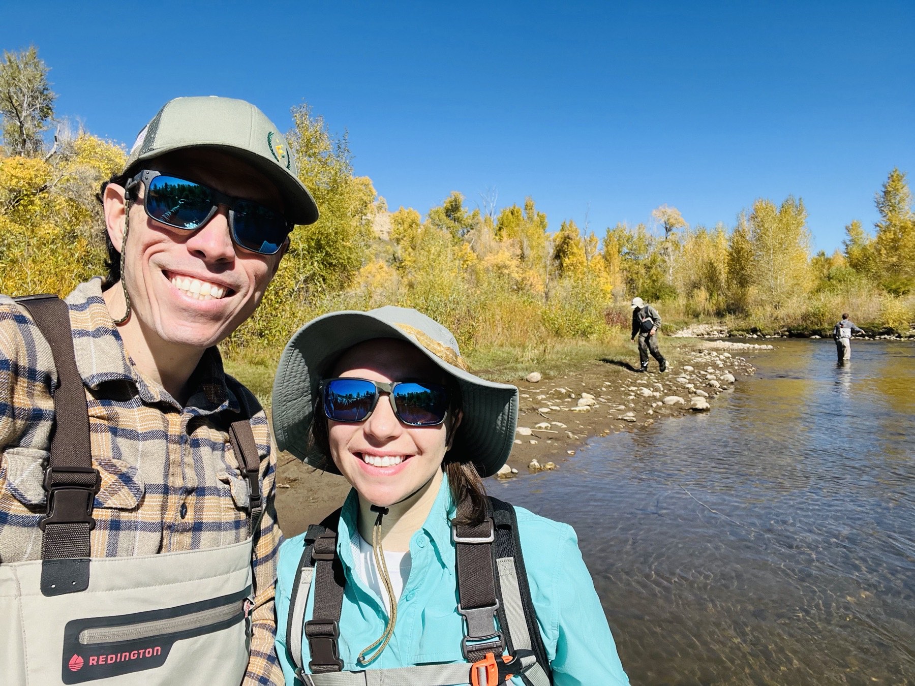 Jaime Gallardo and Tawnya Jones fly fishing on a river in autumn