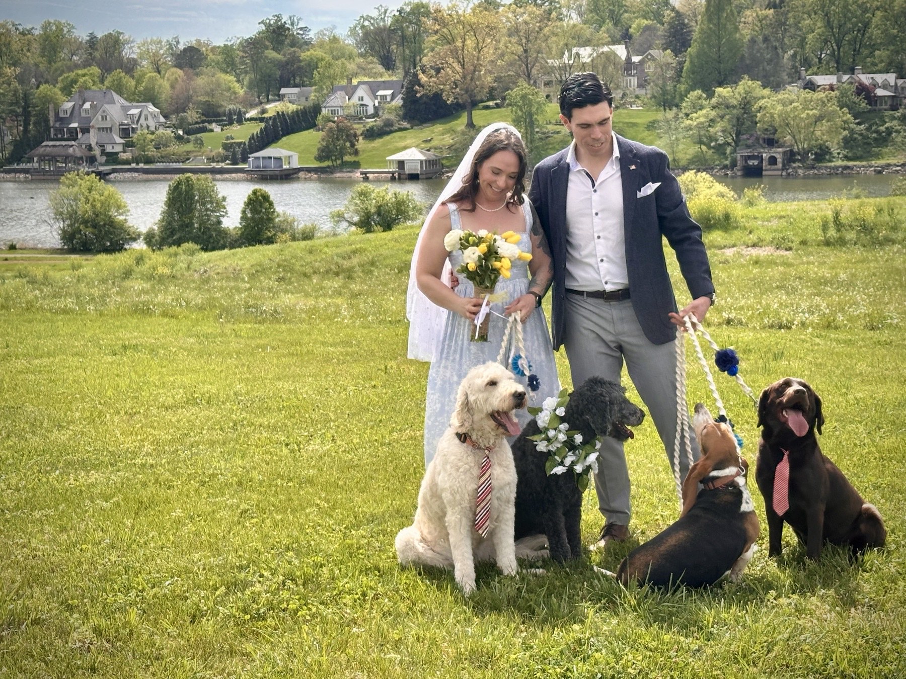 Jaime Gallardo and Tawnya Jones on their wedding day with their four dogs by the lake